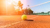Wide angle close-up photograph of tennis ball on court